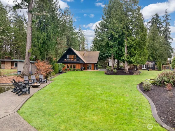 a view of a house with backyard porch and sitting area