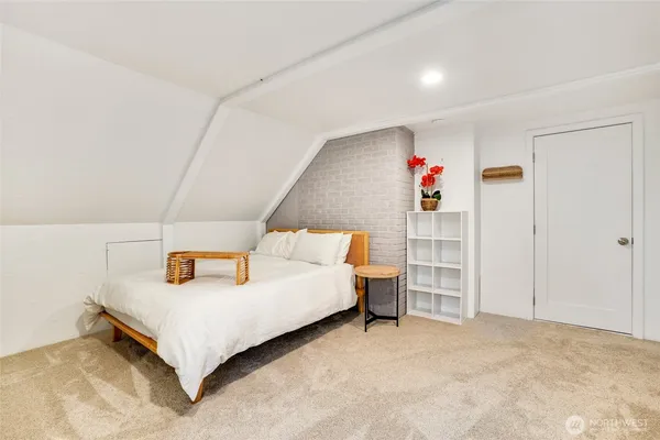 a bed room with a bed and a potted plant