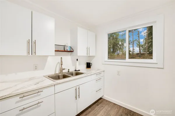 a kitchen with a sink cabinets and window
