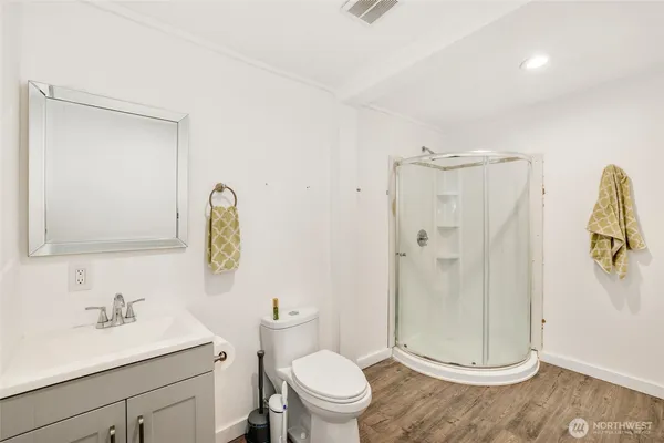 a bathroom with a granite countertop sink toilet and shower