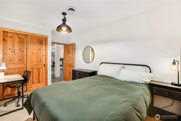 a bedroom with a bed and a chandelier