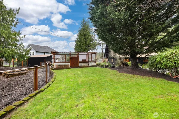 a view of a house with backyard and sitting area