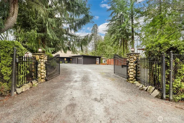 a view of a yard with wooden fence