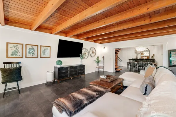 a living room with furniture a flat screen tv and a large window