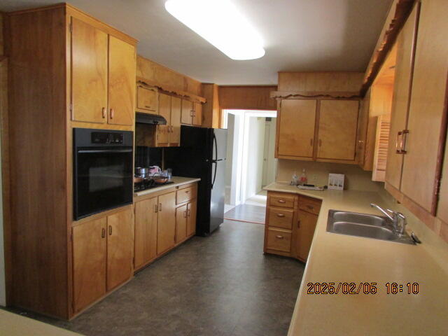 608 West Ave J Muleshoe, TX 79347 - Photo 11 of 25 a kitchen with a refrigerator stove and sink