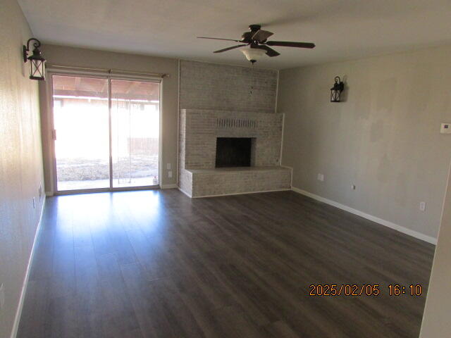 608 West Ave J Muleshoe, TX 79347 - Photo 10 of 25 a view of empty room with wooden floor and fireplace
