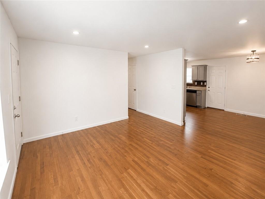 1929 Wee Kirk Road Southeast Atlanta, GA 30316 - Photo 5 of 22 a view of empty room with wooden floor and kitchen