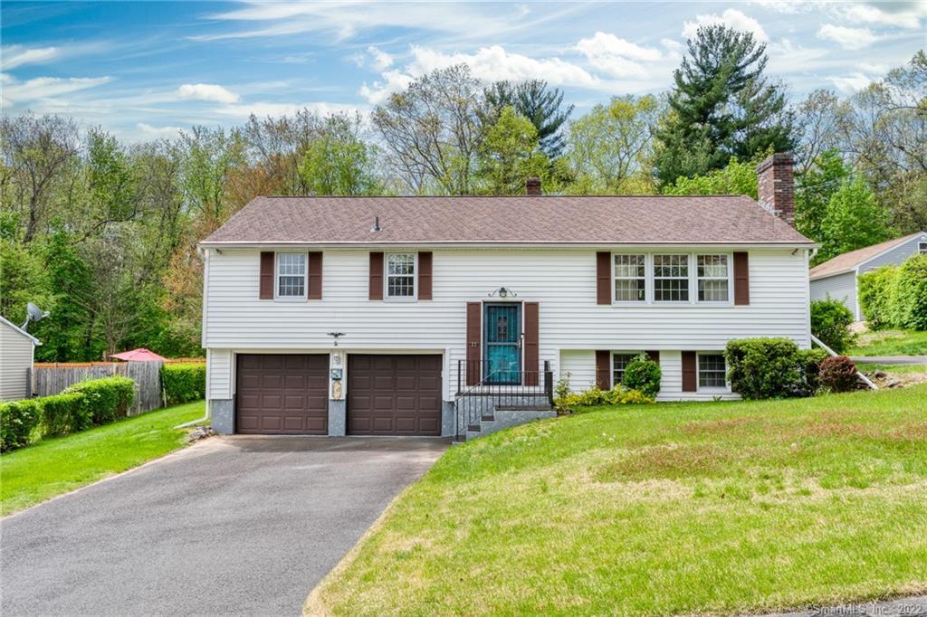 12 Hillcrest Road Enfield, CT 06082 - Photo 1 of 1 a front view of a house with a yard and trees