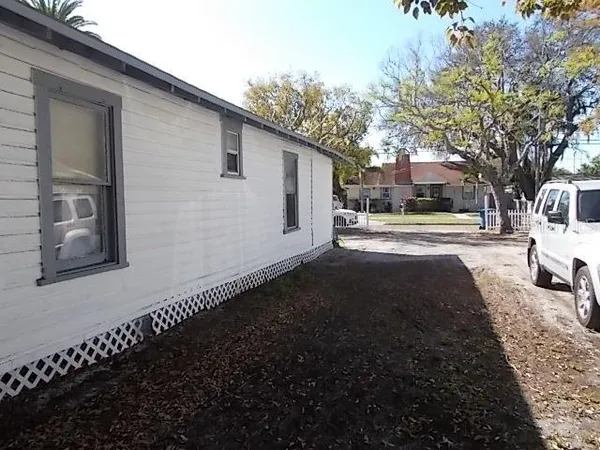 a view of a house with backyard and sitting area