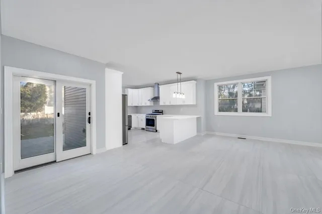 a view of kitchen with refrigerator sink and cabinets
