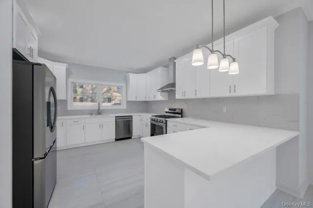 a kitchen with cabinets and stainless steel appliances