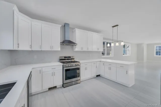 a kitchen with white cabinets and appliances