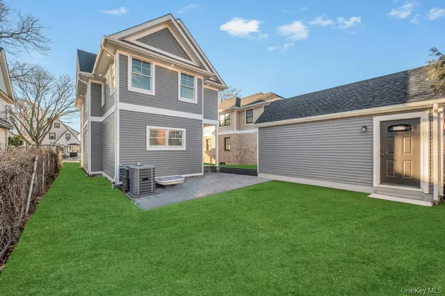 a front view of a house with a yard and sitting area