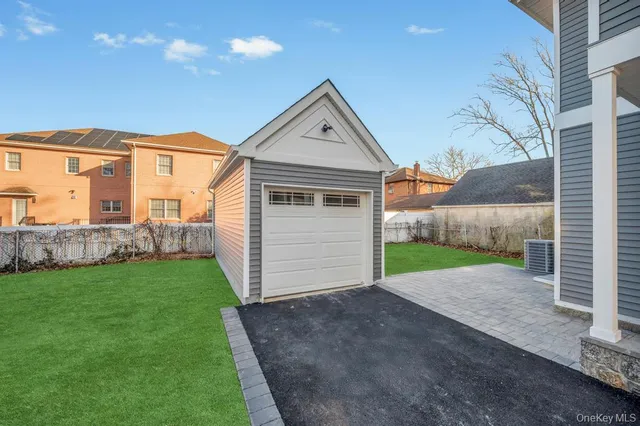 a view of a house with a yard and garage