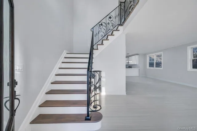a view of entryway with wooden floor and stairs
