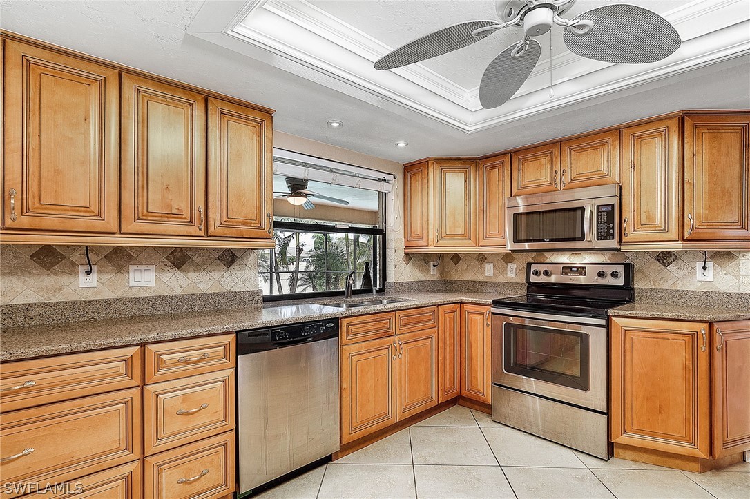 17516 Ingram Road Fort Myers, FL 33967 - Photo 12 of 26 a kitchen with stainless steel appliances granite countertop a stove sink and microwave
