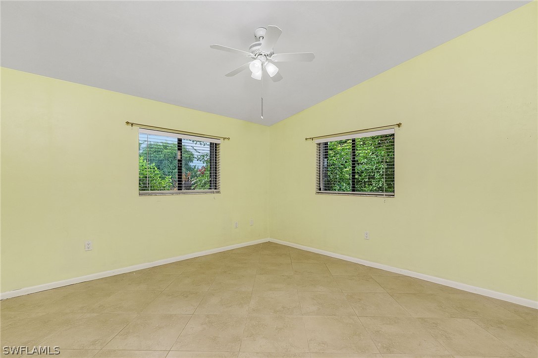 17516 Ingram Road Fort Myers, FL 33967 - Photo 15 of 26 an empty room with a ceiling fan and window