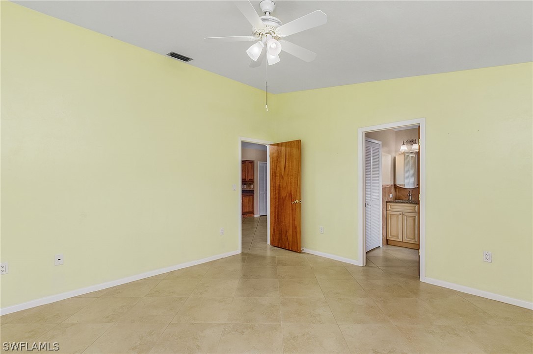 17516 Ingram Road Fort Myers, FL 33967 - Photo 16 of 26 a view of an empty room with chandelier fan