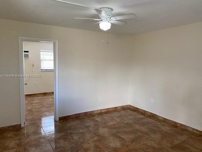 Glenvar Heights Miami, FL 33155 - Photo 4 of 12 an empty room with windows and fan