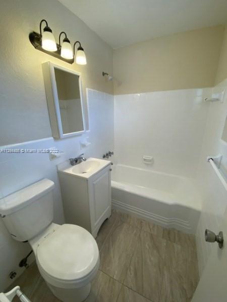 Glenvar Heights Miami, FL 33155 - Photo 10 of 12 a bathroom with a toilet sink and mirror