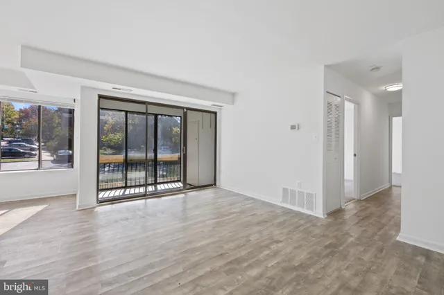 a view of an empty room with glass door