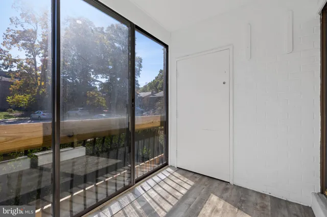 a view of a glass door with a yard from a corridor