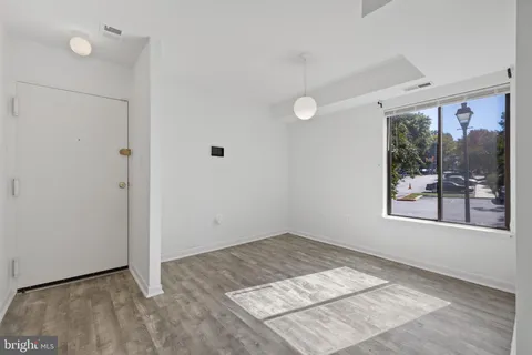 an empty room with a window and doors