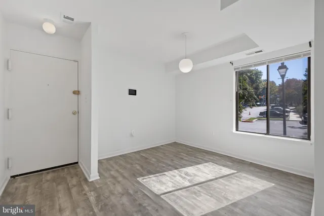 an empty room with a window and doors