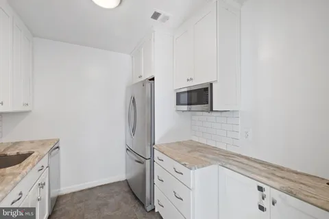 a kitchen with a stove and a refrigerator