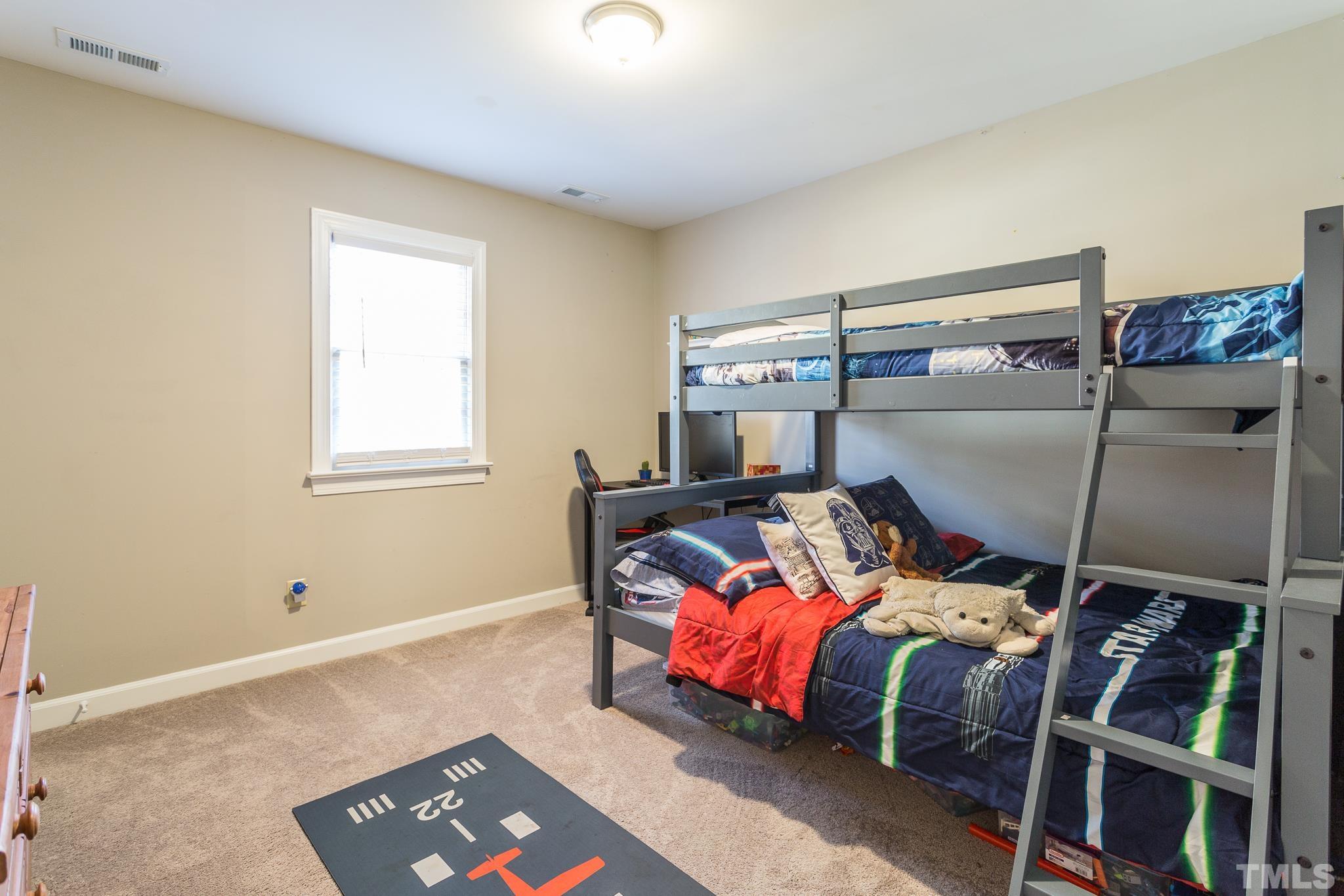 7013 Sandringham Drive Raleigh, NC 27613 - Photo 12 of 25 a bed room with a bed and window