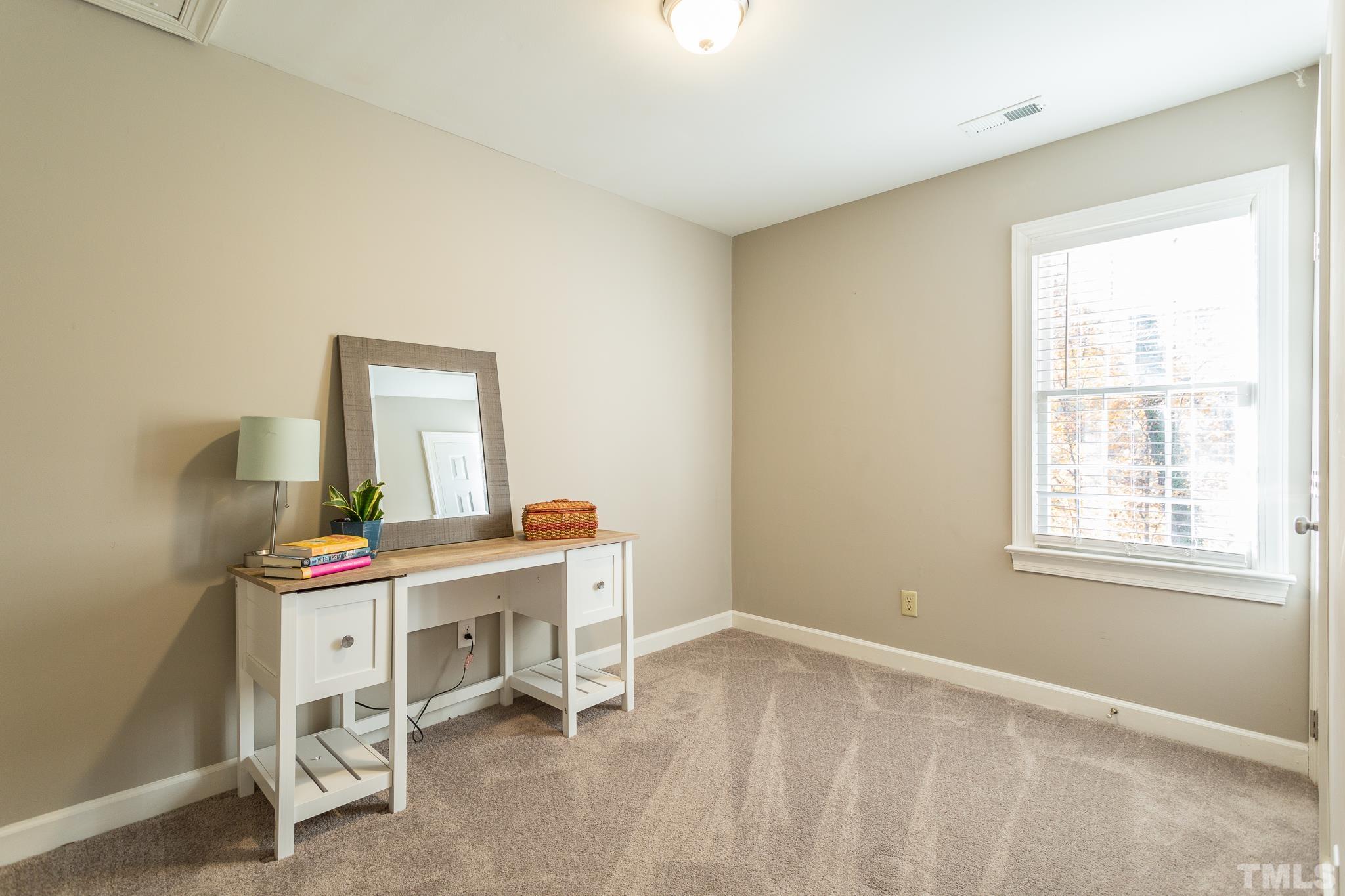 7013 Sandringham Drive Raleigh, NC 27613 - Photo 14 of 25 a view of a workspace with furniture and a window