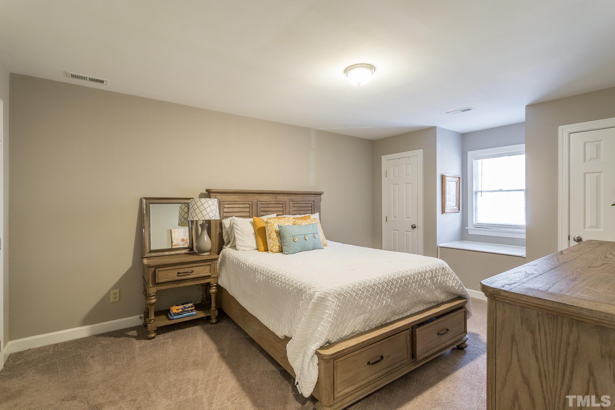 7013 Sandringham Drive Raleigh, NC 27613 - Photo 16 of 25 a bedroom with a bed and a window