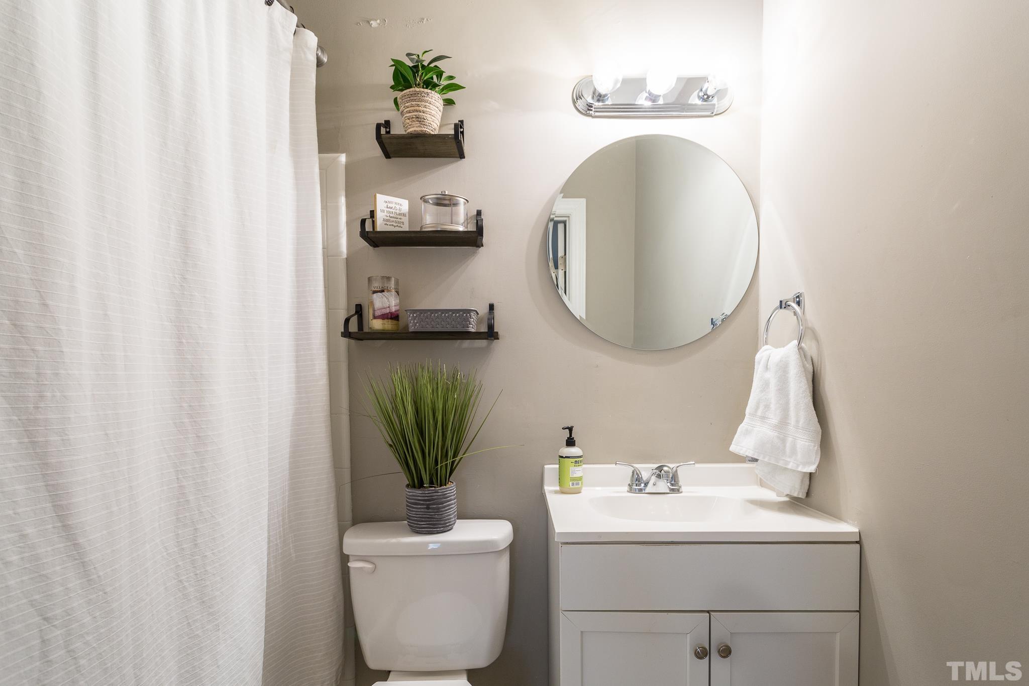 7013 Sandringham Drive Raleigh, NC 27613 - Photo 18 of 25 a bathroom with a sink toilet and mirror