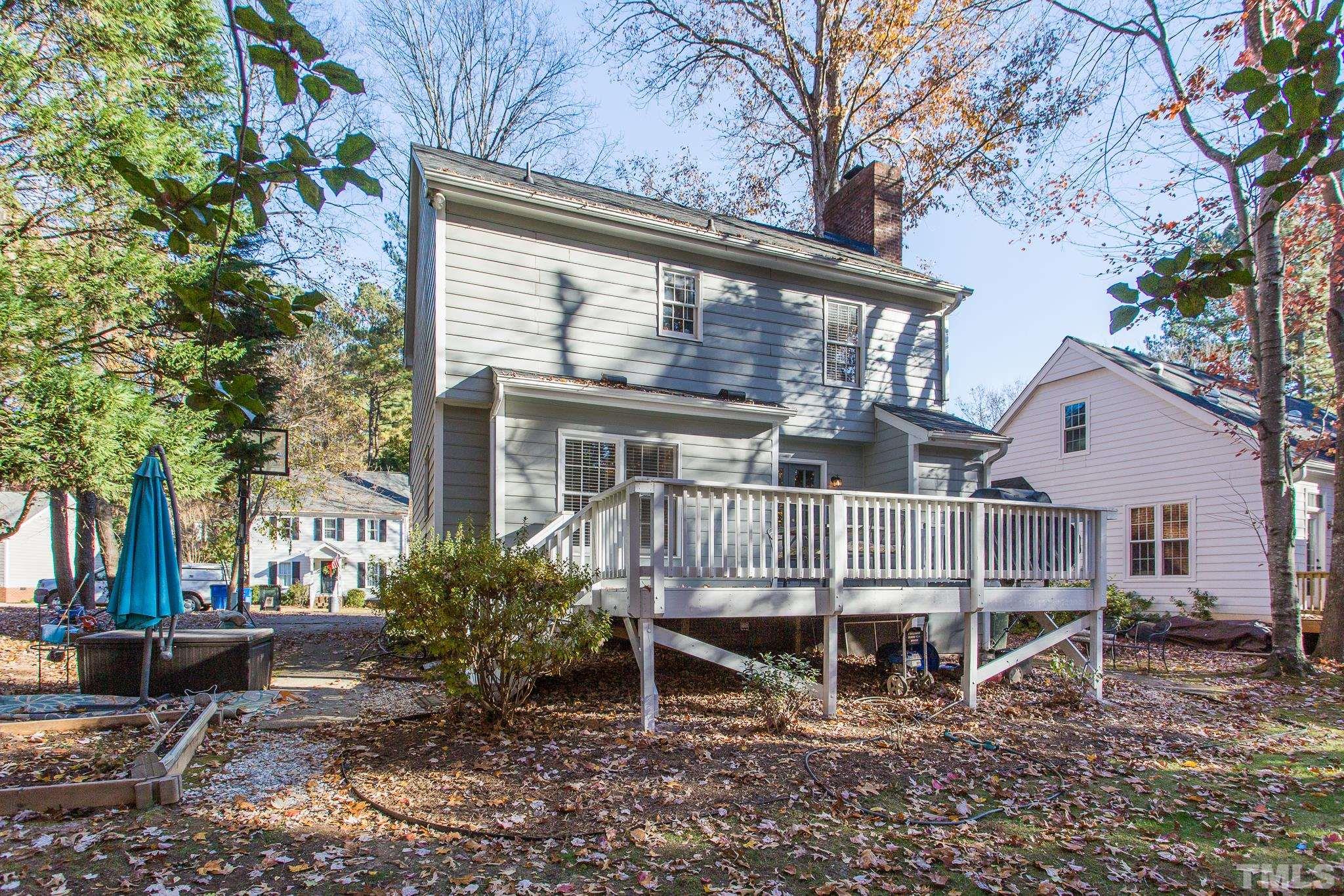 7013 Sandringham Drive Raleigh, NC 27613 - Photo 25 of 25 a view of a house with a yard and sitting area