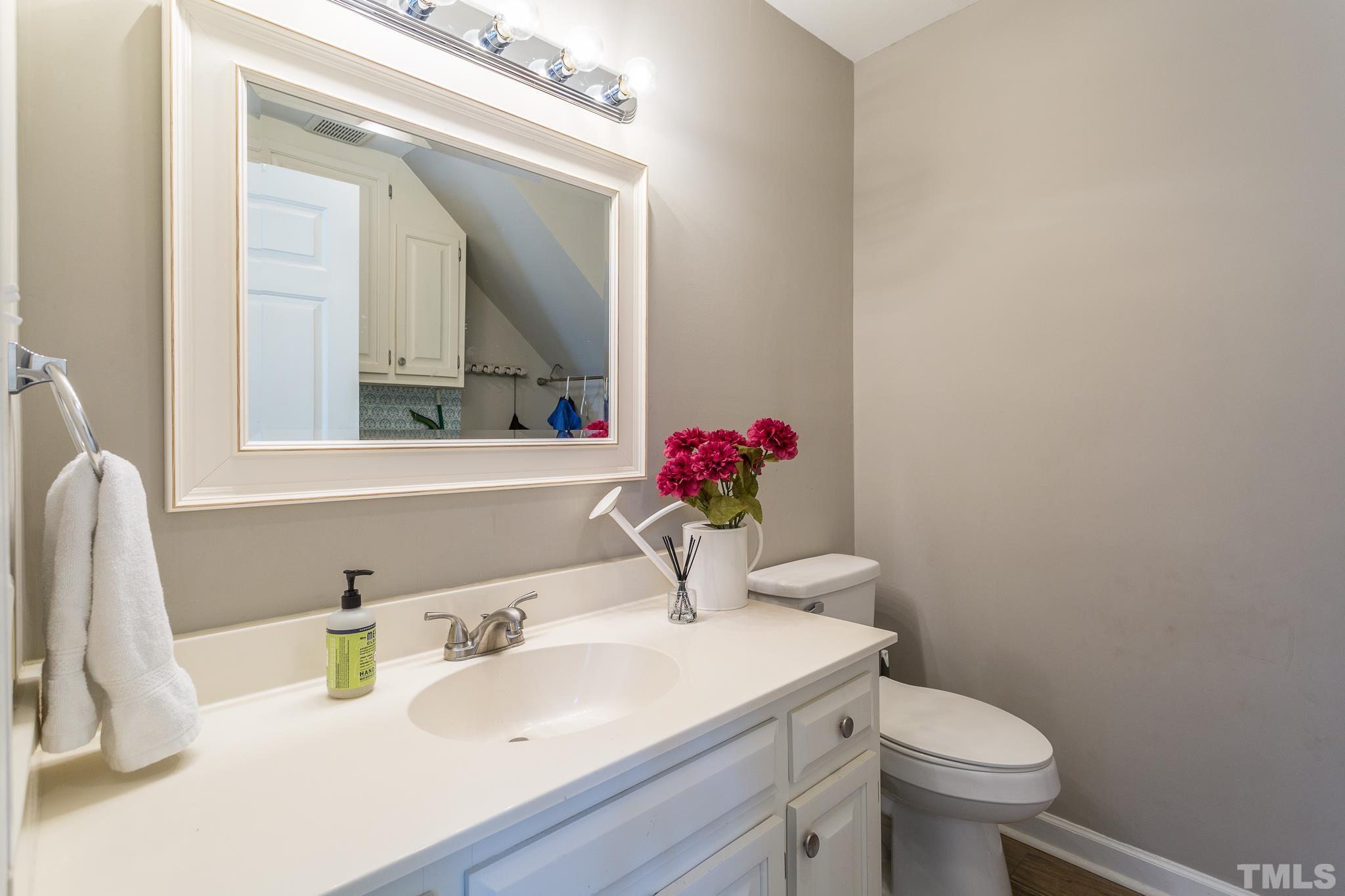 7013 Sandringham Drive Raleigh, NC 27613 - Photo 10 of 25 a bathroom with a sink vanity mirror and toilet
