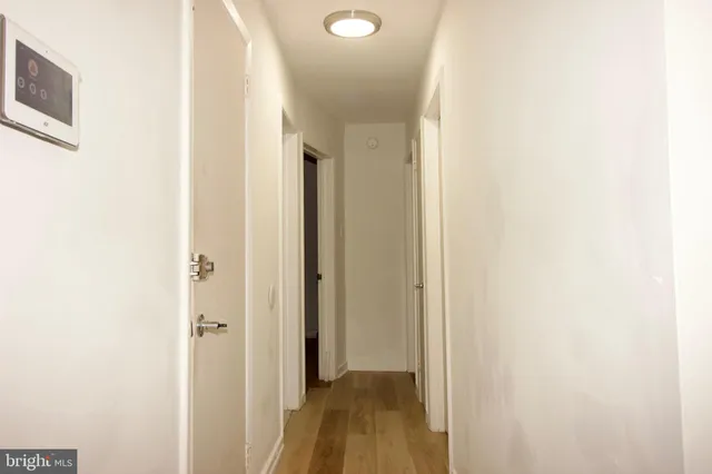 a view of a hallway with wooden floor