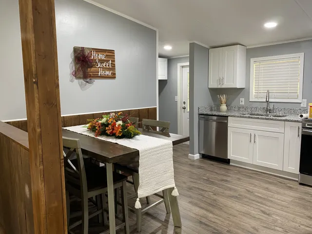a kitchen with a table and chairs