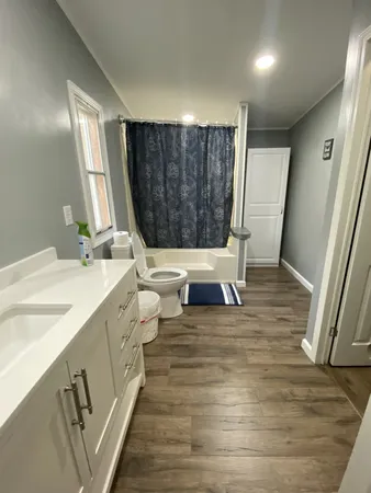 a living room with a sink furniture and a wooden floor