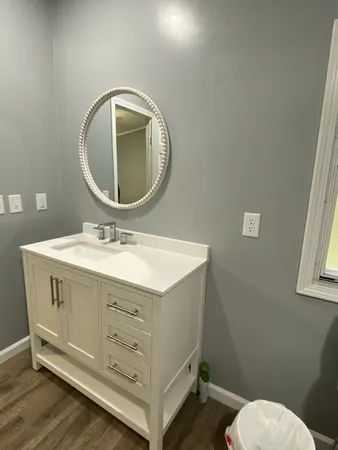 a bathroom with a sink mirror and toilet
