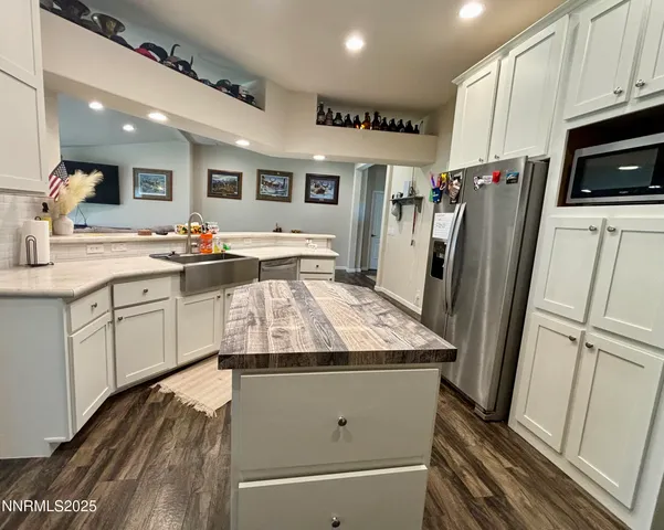 a kitchen with stainless steel appliances granite countertop a refrigerator sink and microwave