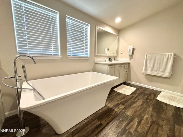 a spacious bathroom with a tub and sink
