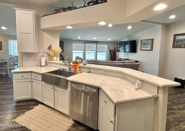 a kitchen with granite countertop a sink and cabinets