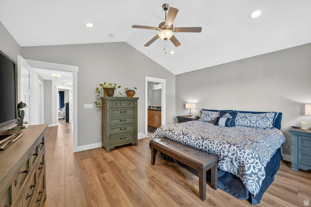 7872 Farm House Lane Midvale, UT 84047 - Photo 17 of 39 Primary bedroom. Vaulted ceiling with a ceiling fan and recessed lighting, wood-finish flooring, and white trim molding
