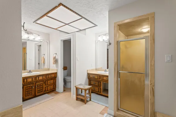 a spacious bathroom with a double vanity sink and a mirror