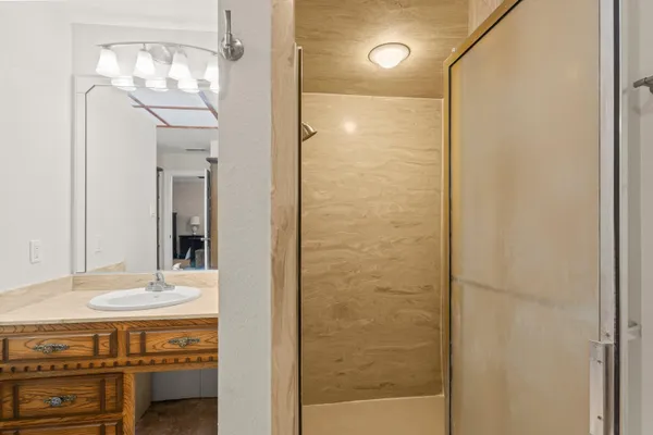 a bathroom with a mirror and a shower
