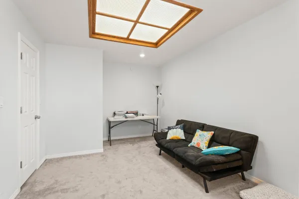a living room with furniture and a painting