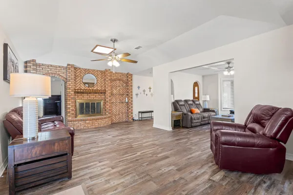 a living room with furniture a fireplace and a flat screen tv