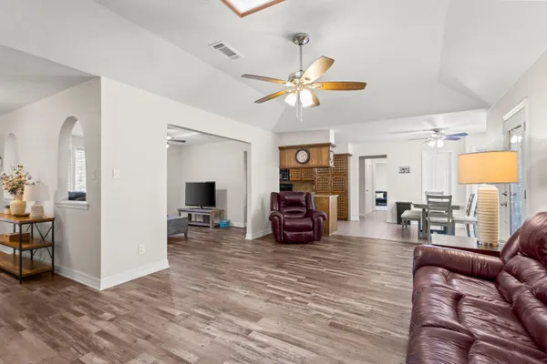 a view of a livingroom with furniture and a ceiling fan