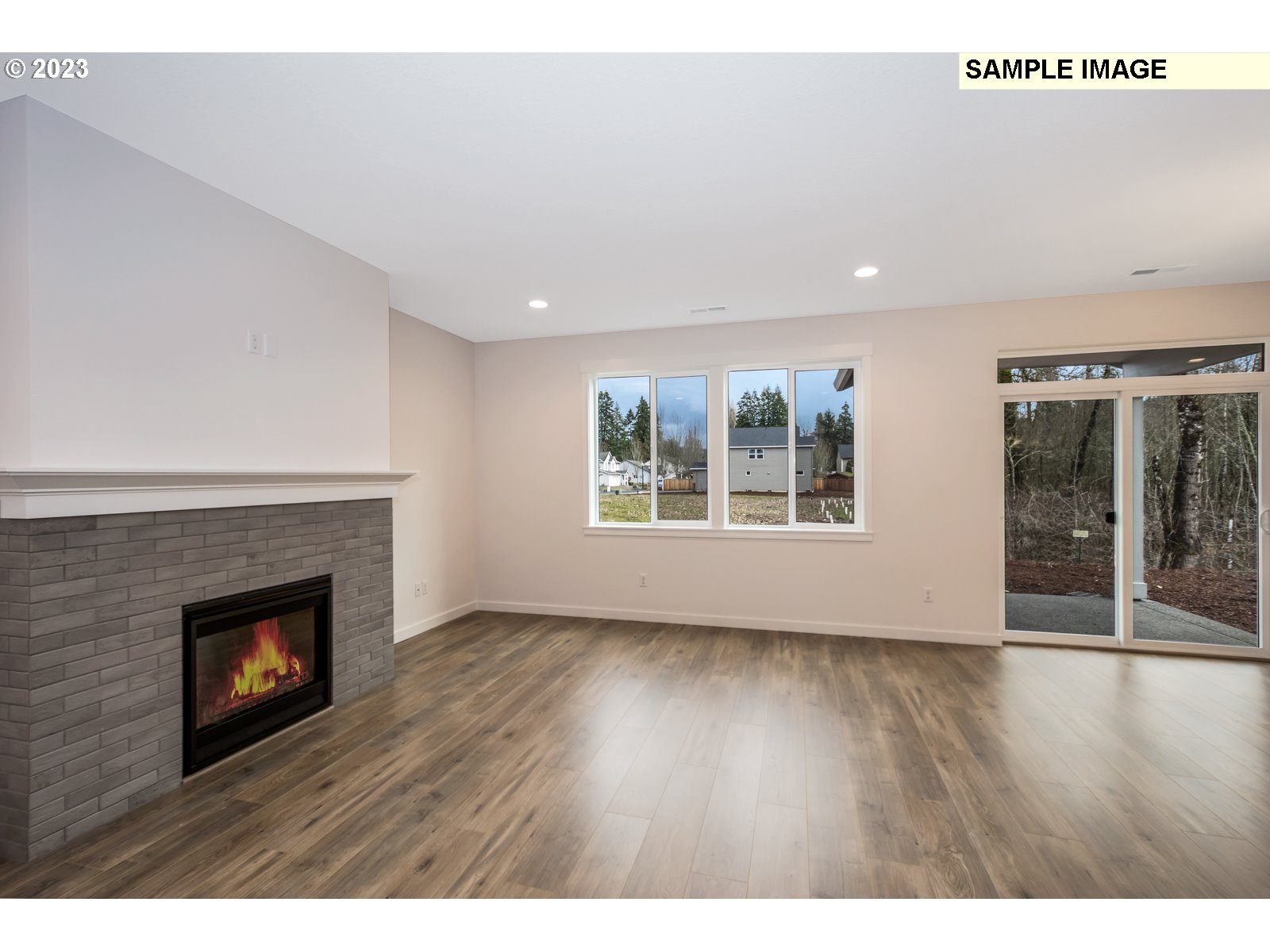 217 South 87th, Unit 46 Ridgefield, WA 98642 - Photo 17 of 24 a view of an empty room with wooden floor fireplace and a window