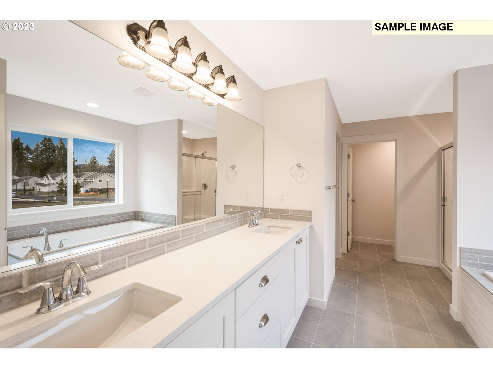 217 South 87th, Unit 46 Ridgefield, WA 98642 - Photo 8 of 24 a spacious bathroom with a sink a large mirror and a shower